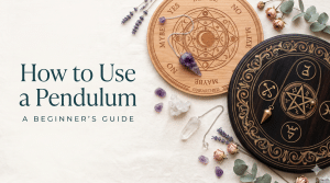 How to use a pendulum: a flat lay of pendulum boards and crystal pendulums